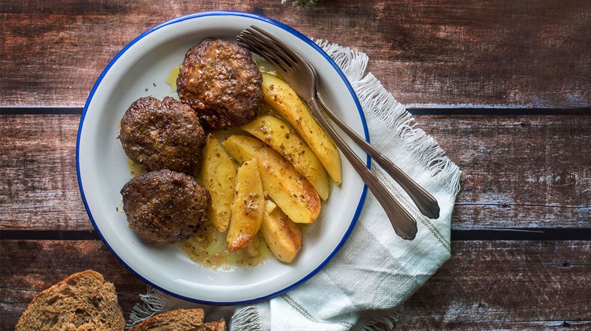 Greek baked burger patties (Biftekia) with potatoes
